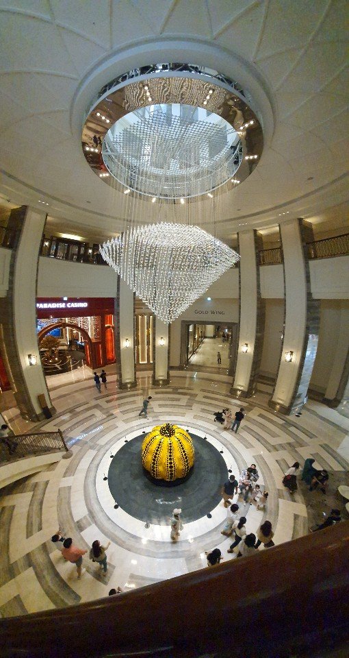 Paradise City lobby from above: chandelier and Yayoi Kusama pumpkin
