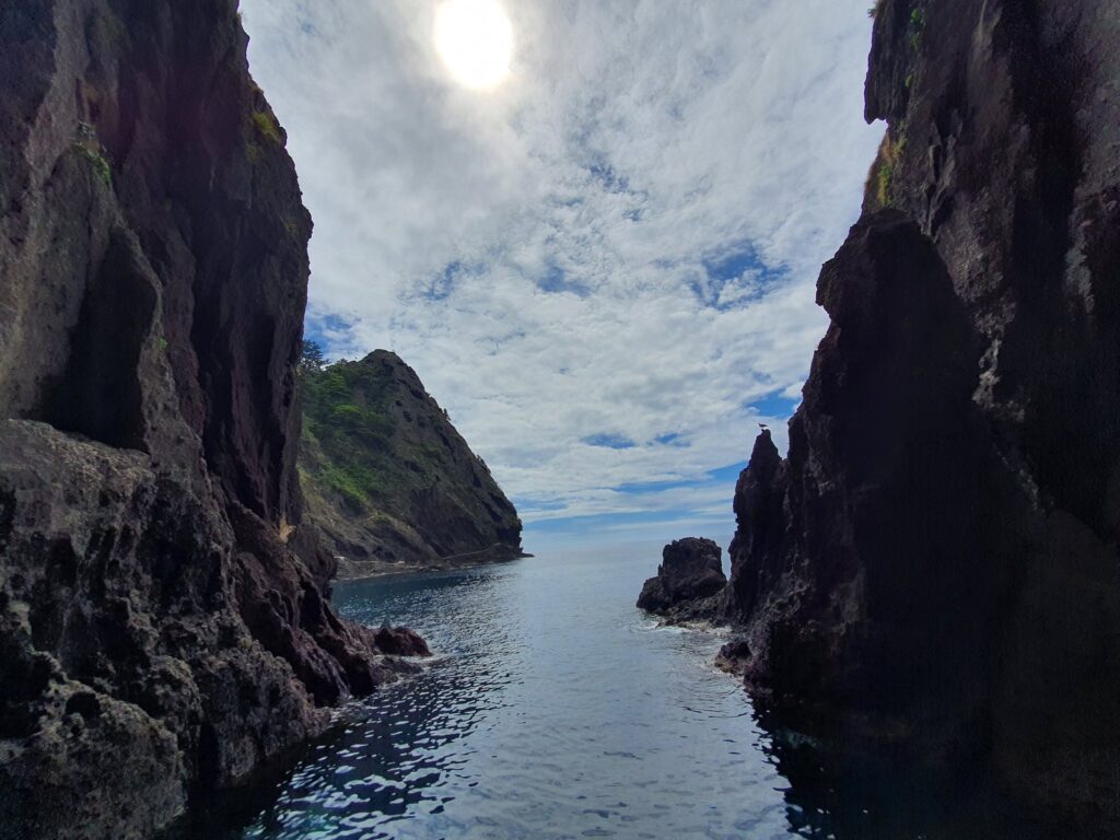 Narrow rock gorge with blue water on the Haengnam Coastal Walk, Ulleungdo