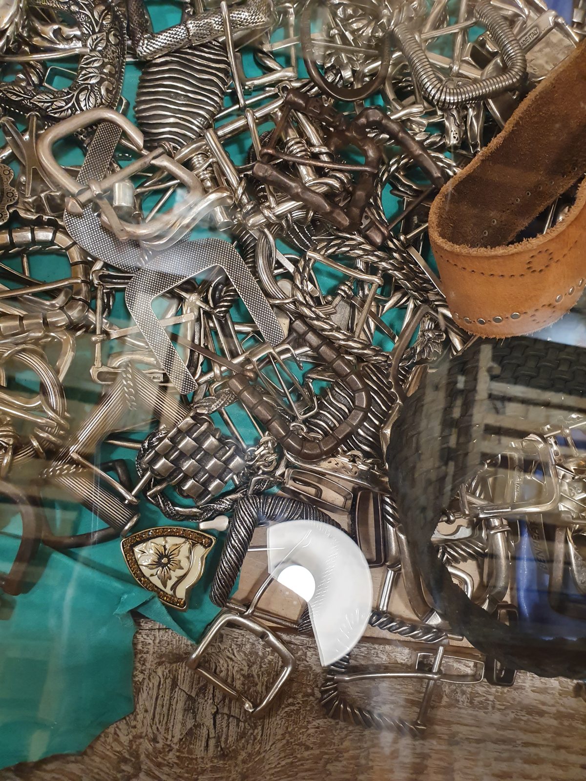 Pile of belt buckles to choose from at Benheart, Florence