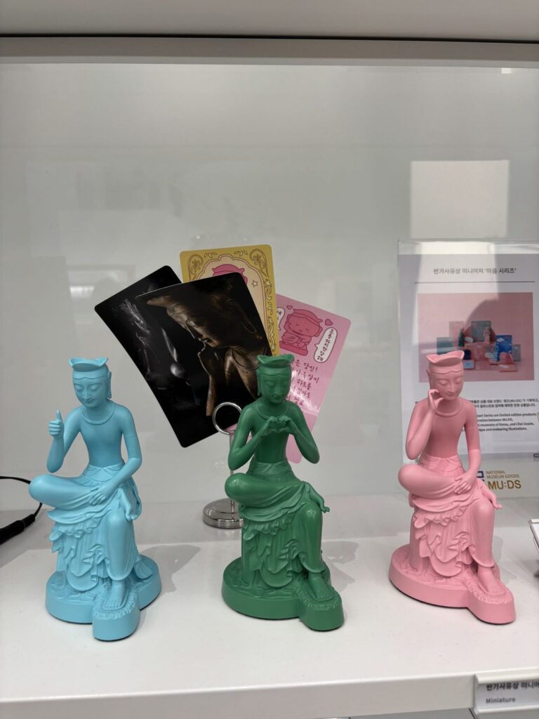 Mini Pensive Bodhisattva figures in pastel colors at the museum shop