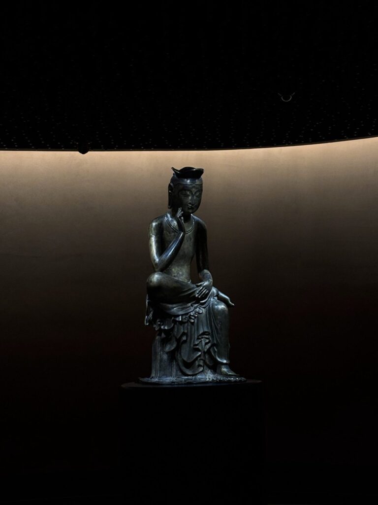 Pensive Bodhisattva bronze statue in the Room of Quiet Contemplation, National Museum of Korea