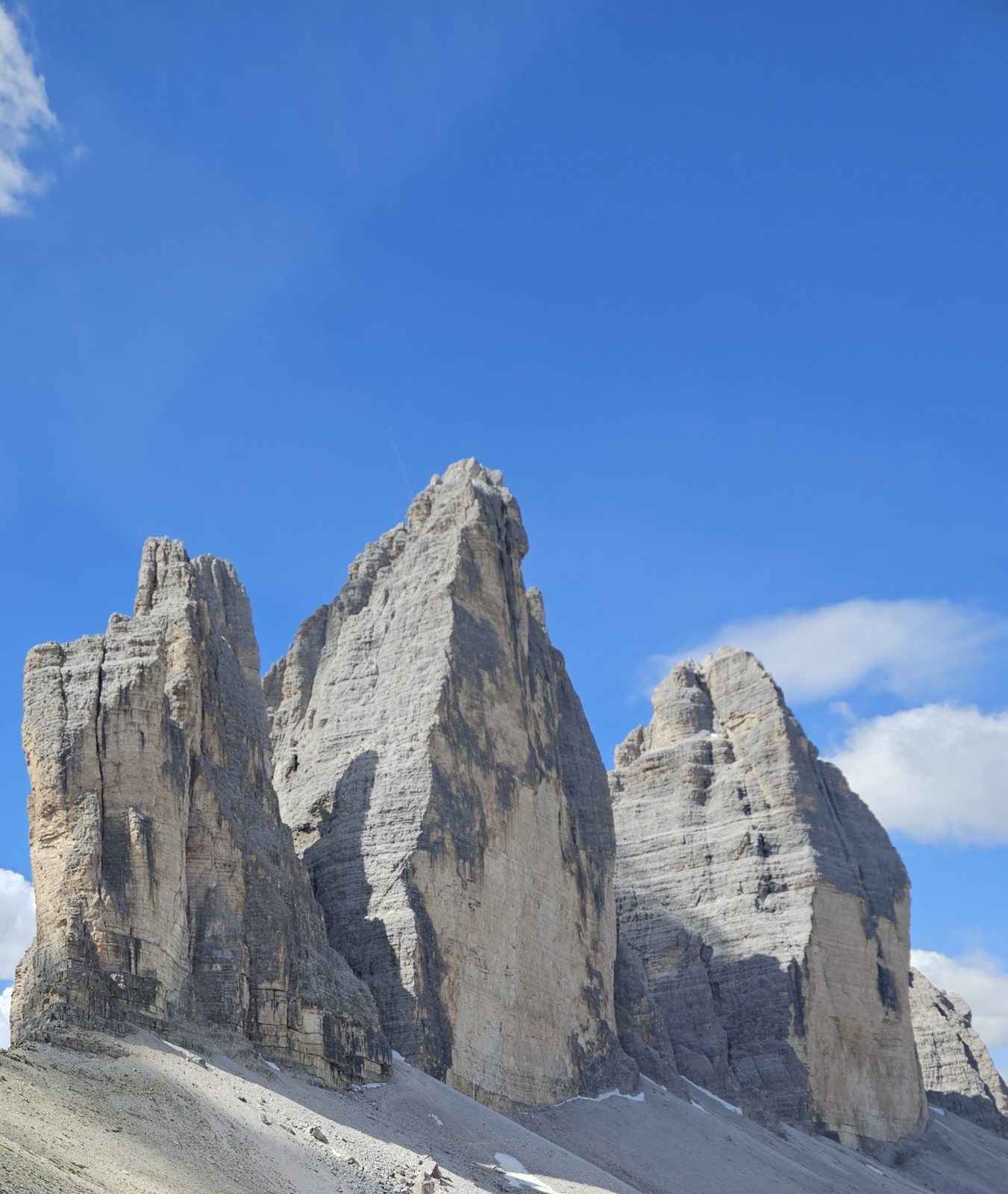 The three peaks of Tre Cime di Lavaredo against a blue sky