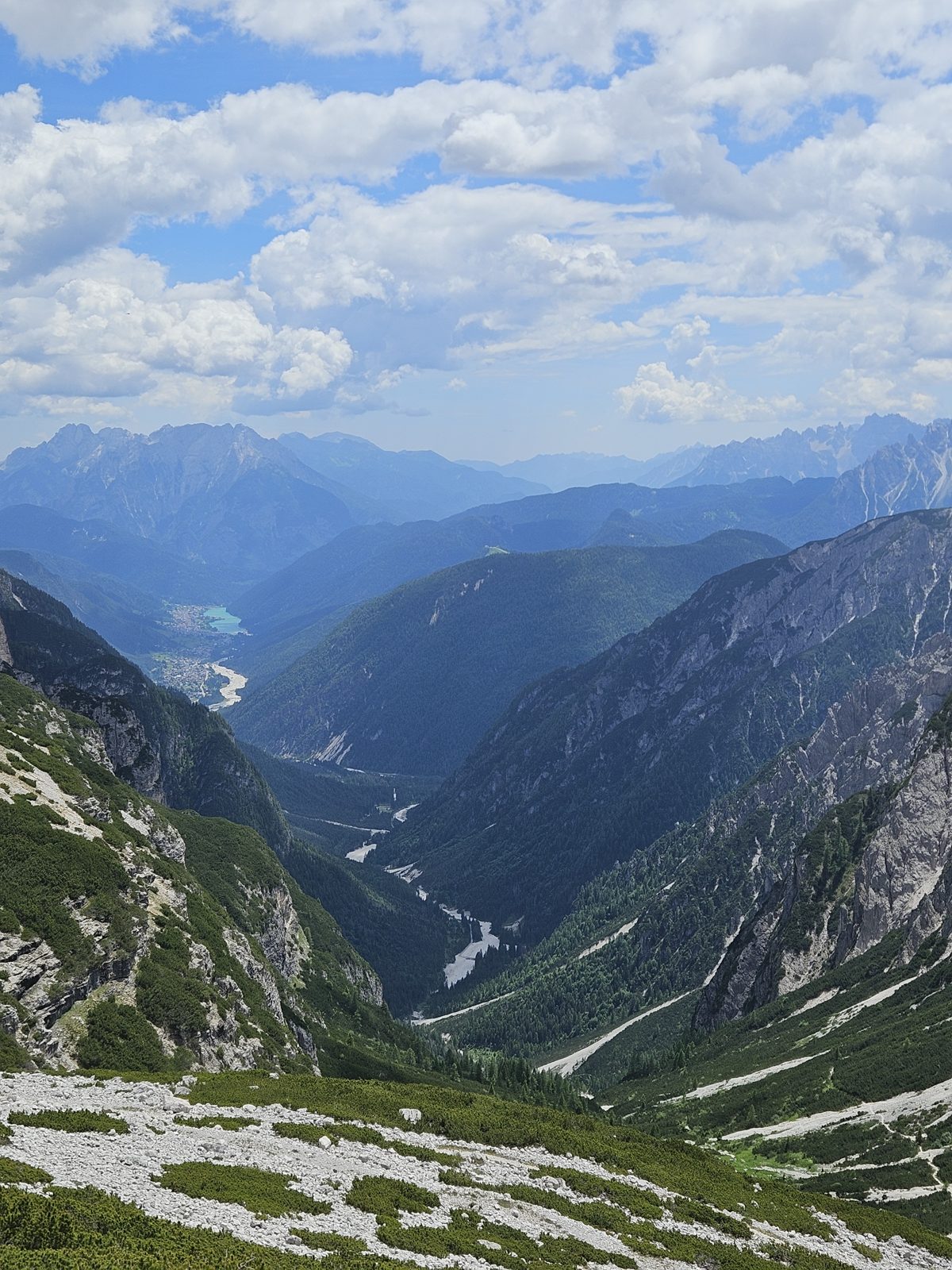 Deep green valley and a lake seen from the Tre Cime trail